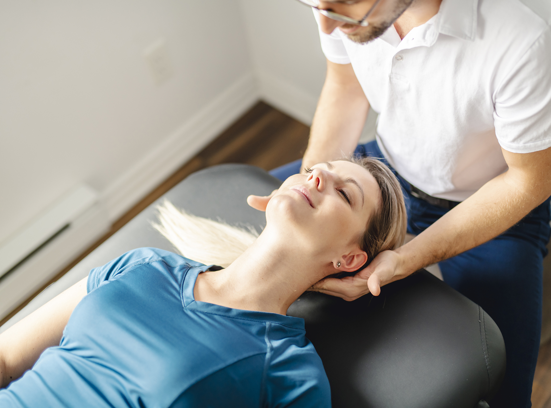 Chiropractor adjusting woman's neck